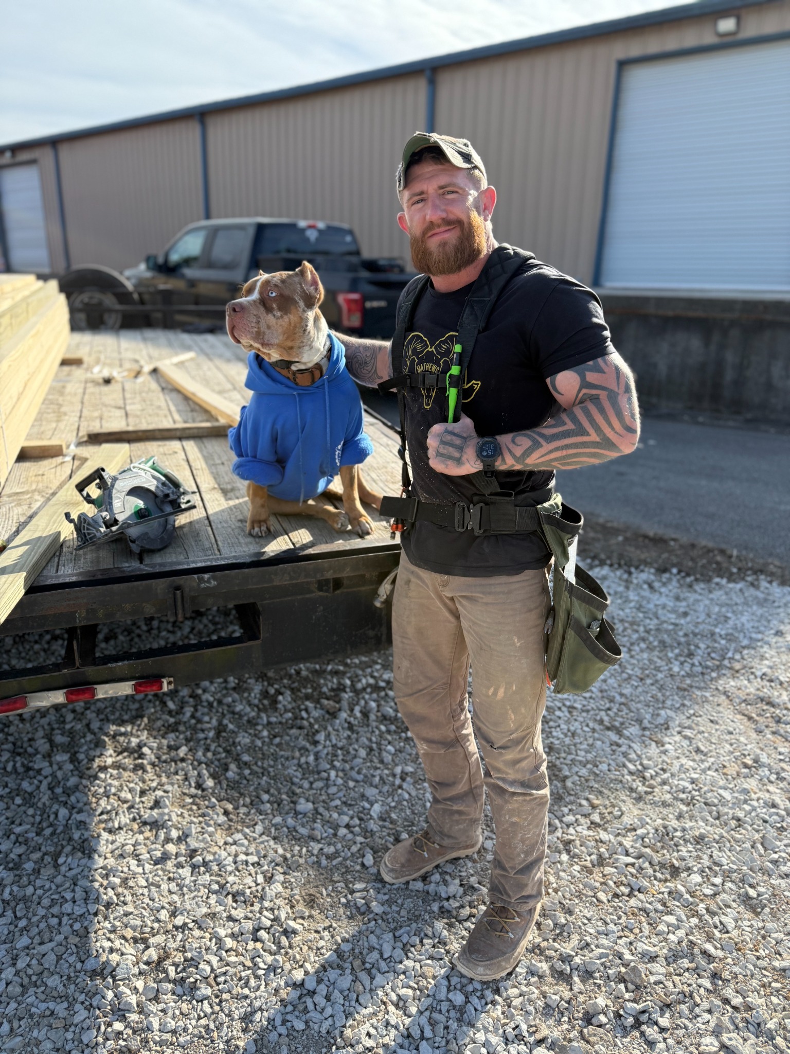 CJ Pipkin with his American Bully, Gator, at a construction job site